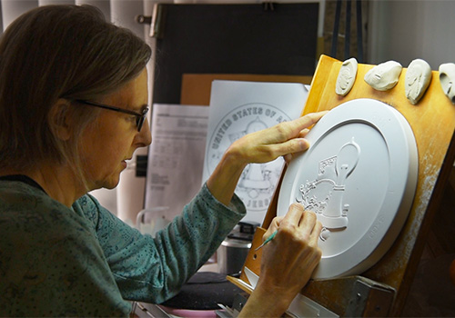U.S. Mint medallic artist sculpts a clay coin model