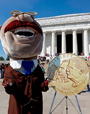 Washington Nationals Running President Teddy Roosevelt holds a NPS commemorative coin.