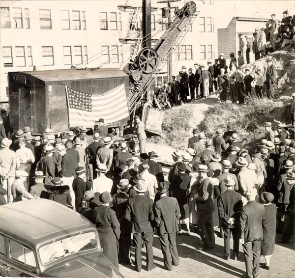 crowd gathered around a construction crane