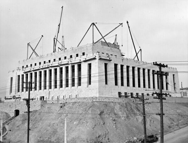 cranes rising above the construction site of the San Francisco Mint