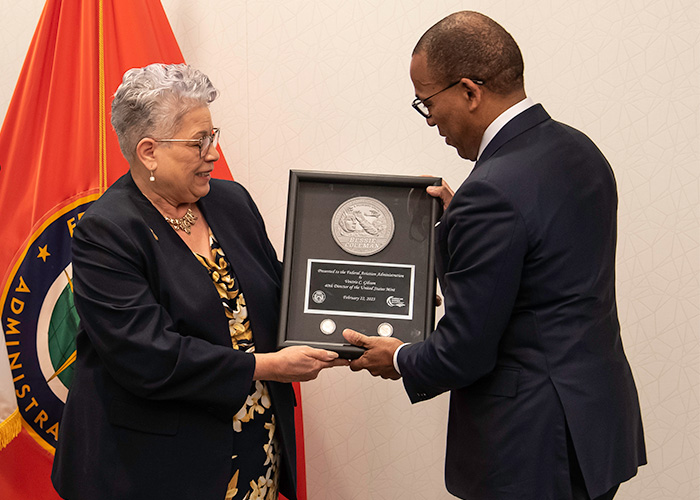 Director Gibson hands a frame to Acting Administrator Bill Nolen