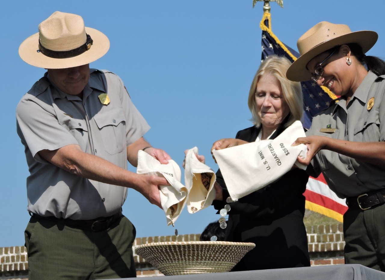 Superintendent Tim Stone, United States Mint Chief Counsel Jean Gentry, and Regional Deputy Director Sherri Fields participate in the ceremonial coin pour.