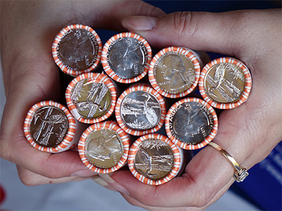 hands holding quarter rolls