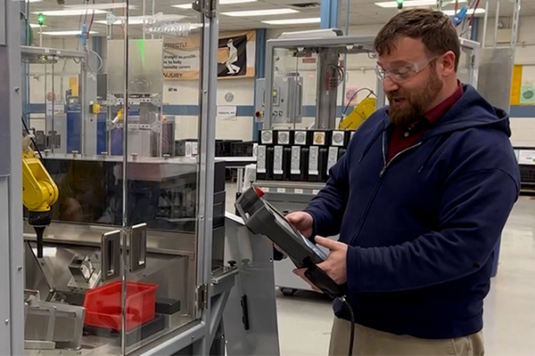 AJ Neider holding a control screen