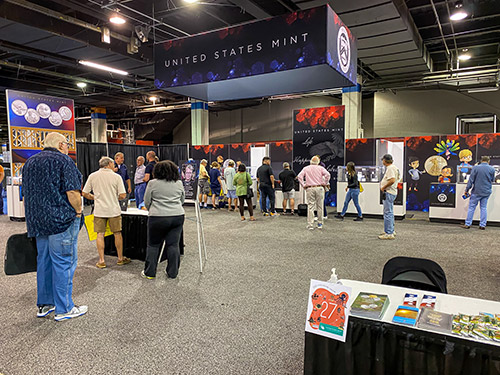 people gathered at the U.S. Mint booth displays
