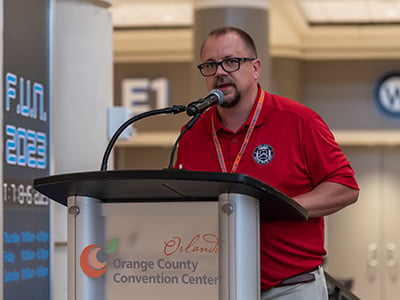 Don Bennett speaking at a podium