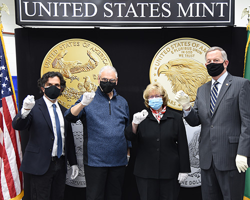 U.S. Mint Director David Ryder and other U.S. Mint staff hold American Eagle coins