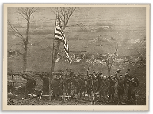 Troops standing beneath an American flag
