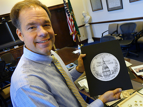 William Krawczewicz, designer of the Maryland state quarter, holds a sketch of his work. (U.S. Mint)
