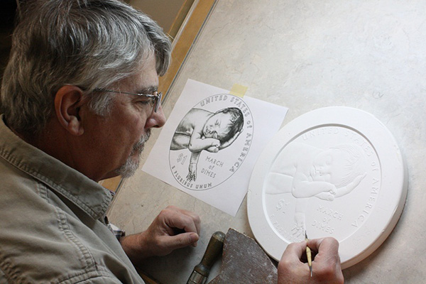 United States Mint Sculptor-Engraver Don Everhart works on a sculpt at the United States Mint at Philadelphia for the 2015 March of Dimes Commemorative Coin Program.