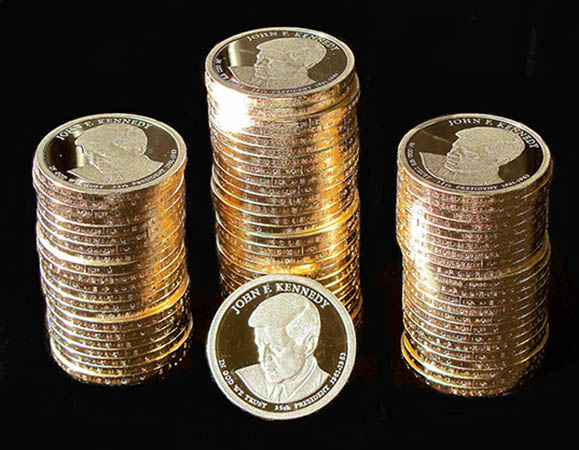 A close up of the John F. Kennedy Presidential $1 Coin, minted in San Francisco, shows that the edge lettering is orientated the same for each coin since edge lettering is integrated into the stamping process.