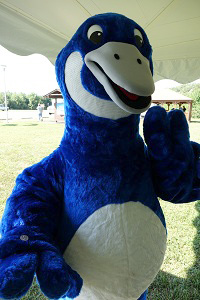 The National Wildlife Refuge System's mascot "Puddles" the blue goose, holds the new Bombay Hook National Wildlife Refuge quarter. U.S. Mint photo by Sharon McPike.
