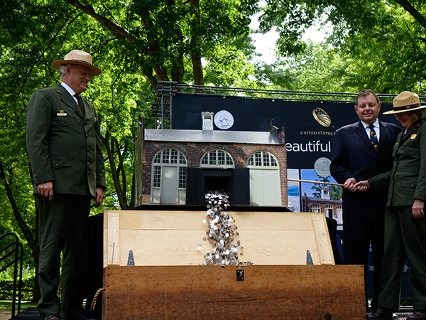 National Park Service Regional Director Bob Vogel, United States Mint Director of Legislative and Intergovernmental Affairs Bill Norton, and Harpers Ferry National Historical Park Superintendent Rebecca Harriett, participate in the ceremonial coin pour.