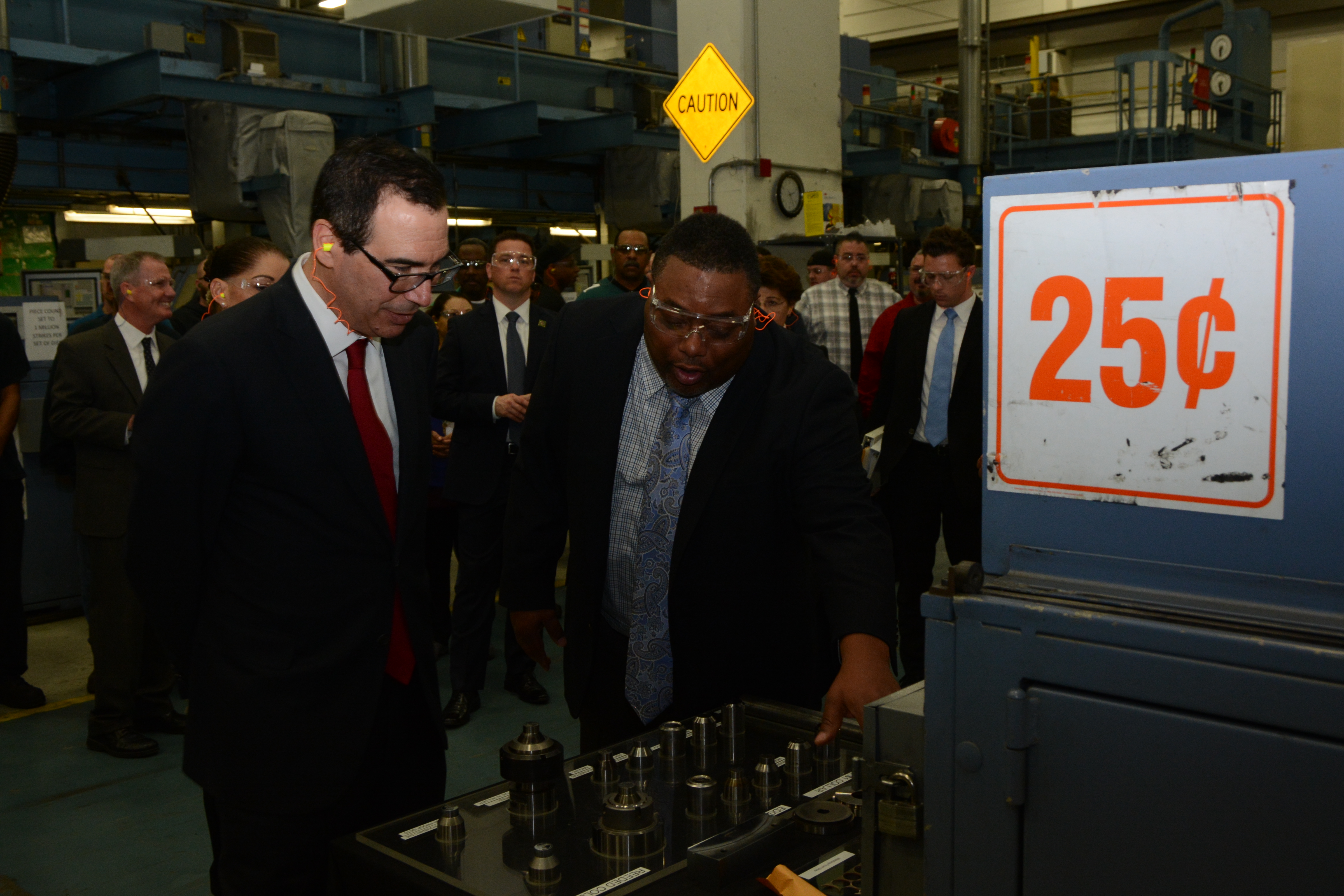 U.S. Mint Coining Division Chief (Philadelphia facility) Norm Patterson discusses hubs and dies with Treasury Secretary Steven Mnuchin on a tour of the circulating production area at the U.S. Mint facility in Philadelphia on February 22, 2018. U.S. Mint p