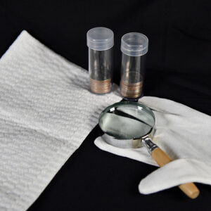 towel, magnifying glass, glove, coins in coin holders