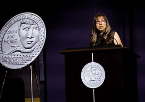 Anna Wong speaks at a podium
