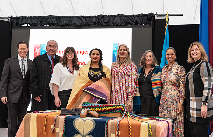 Representatives of Maria Tallchief's family, the Osage Nation, and the Smithsonian with U.S. Treasurer Chief Lynn Malerba, Misty Copeland, and U.S. Mint Program Lead Michele Thompson standing behind a decorated table