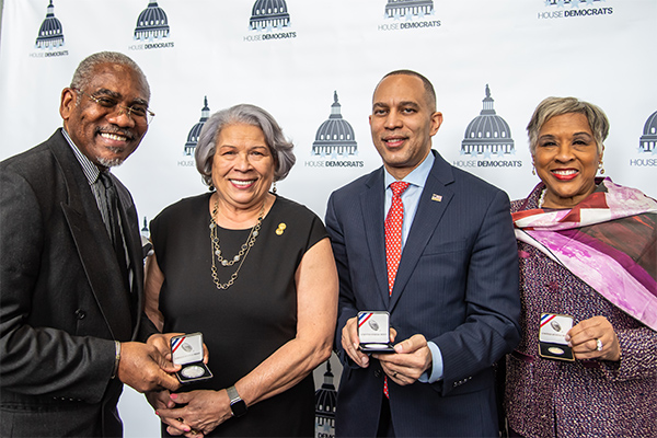Director Gibson with members of Congress holding coins